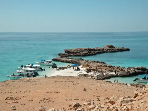 Boats at an island beach on the coast of Oman